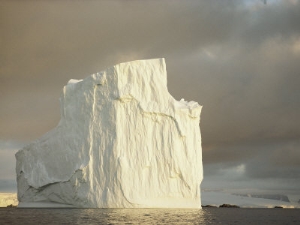 twilight view of a large iceberg under a cloudy sky