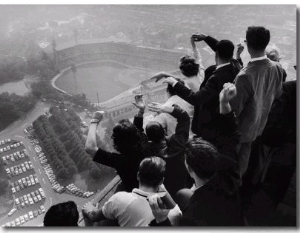 University of Pittsburgh Students Cheering Wildly from Atop Cathedral of Learning on School