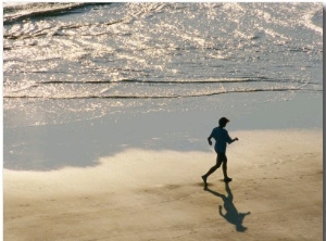 A Jogger Runs Along the Beach
