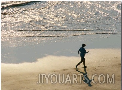A Jogger Runs Along the Beach