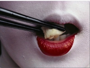 Close View of a Geisha Eating Tofu with Chopsticks
