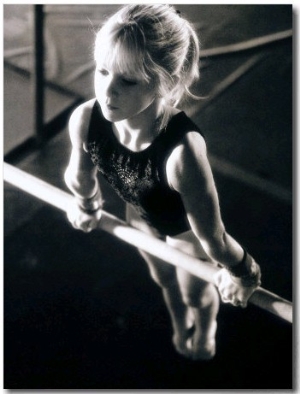 Girl Performing Gymnastics on Uneven Parallel Bars