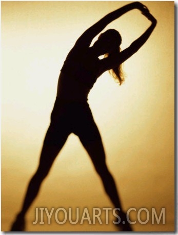 Silhouette of a Woman Exercising