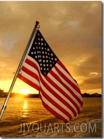 A Flag Waves Over Pearl Harbor as Dawn Breaks