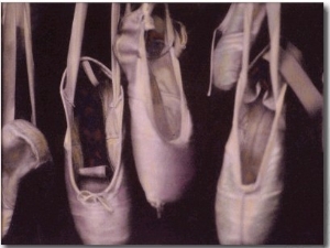 Worn Ballet Shoes Hanging in a Window
