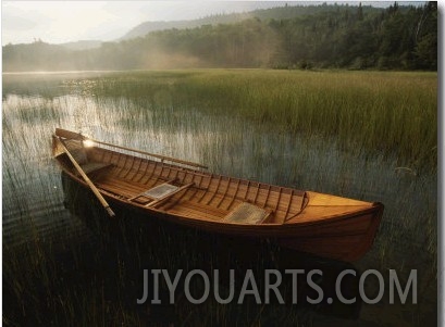 An Adirondack Guide Canoe Floating on Connery Pond at Sunrise
