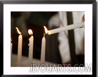 Boy lighting candles at Bar Mitzvah
