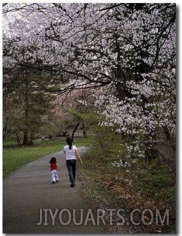 Mother and Child Walking Through Park