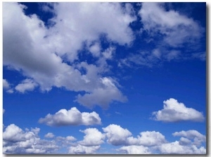 Sunlit Fluffy White Clouds in a Blue Sky