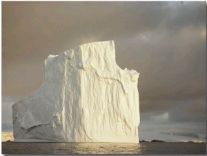 Twilight View of a Large Iceberg Under a Cloudy Sky