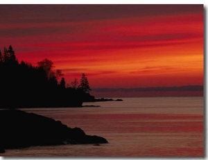 A Bright Red Sky over Lake Superior at Dawn with Silhouettes of the Rocky Coast