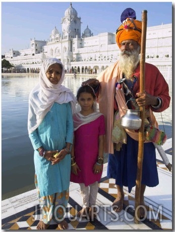 Elderly Couple of Sikh Pilgrims with Young Girl Posing in Front of Holy Pool, Amritsar, India