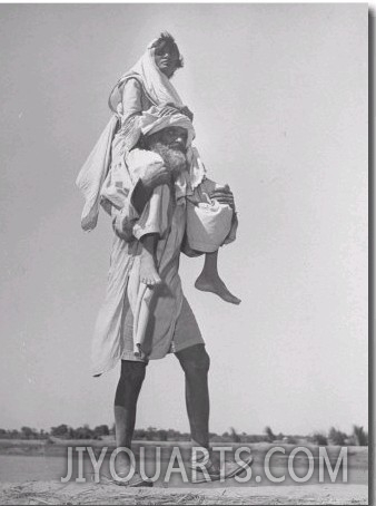 Sikh Carrying His Wife on Shoulders in Convoy Migrating to East Punjab After the Division of India