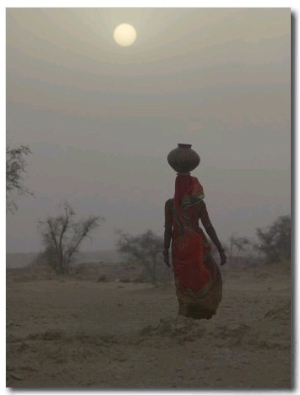 Woman Carrying Water Jar in Sand Storm, Thar Desert, Rajasthan, India