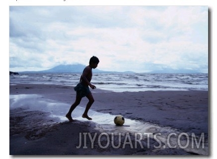 Boy Kicking Soccer Ball on Beach, Lake Nicaragua, Granada, Nicaragua