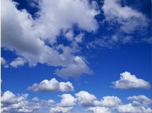 Sunlit Fluffy White Clouds in a Blue Sky