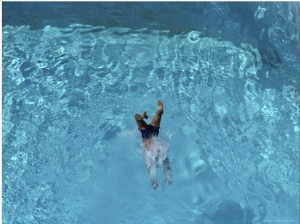 A Swimmer Dives into a Swimming Pool