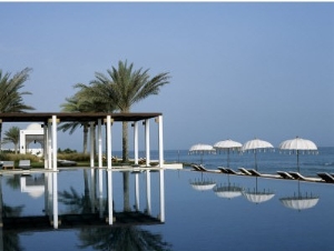Reflections in the Still Water of the Infinity Pool at the Chedi Hotel