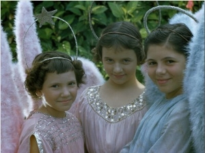 Smiling Young Girls Wear Angel Costumes for an Easter Procession