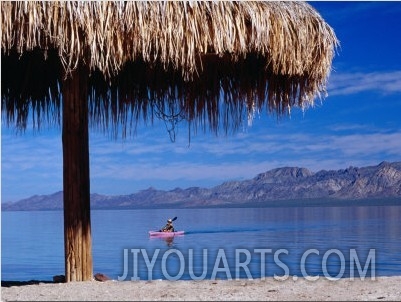 Thatch Umbrella and Canoe Paddler at Beach Playa Buenaventura Palapa, Baja California Sur, Mexico