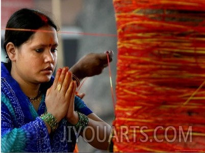 A Woman Offers Prayers to a Banyan Tree Covered by Sacred Thread