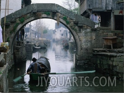A Bamboo Boat Makes Its Way Through Shaoxing Water Town, Shaoxing, Zhejiang, China