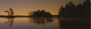 Silhouette of a Person in a Canoe on a Lake, Kejimkujik Lake, Nova Scotia, Canada